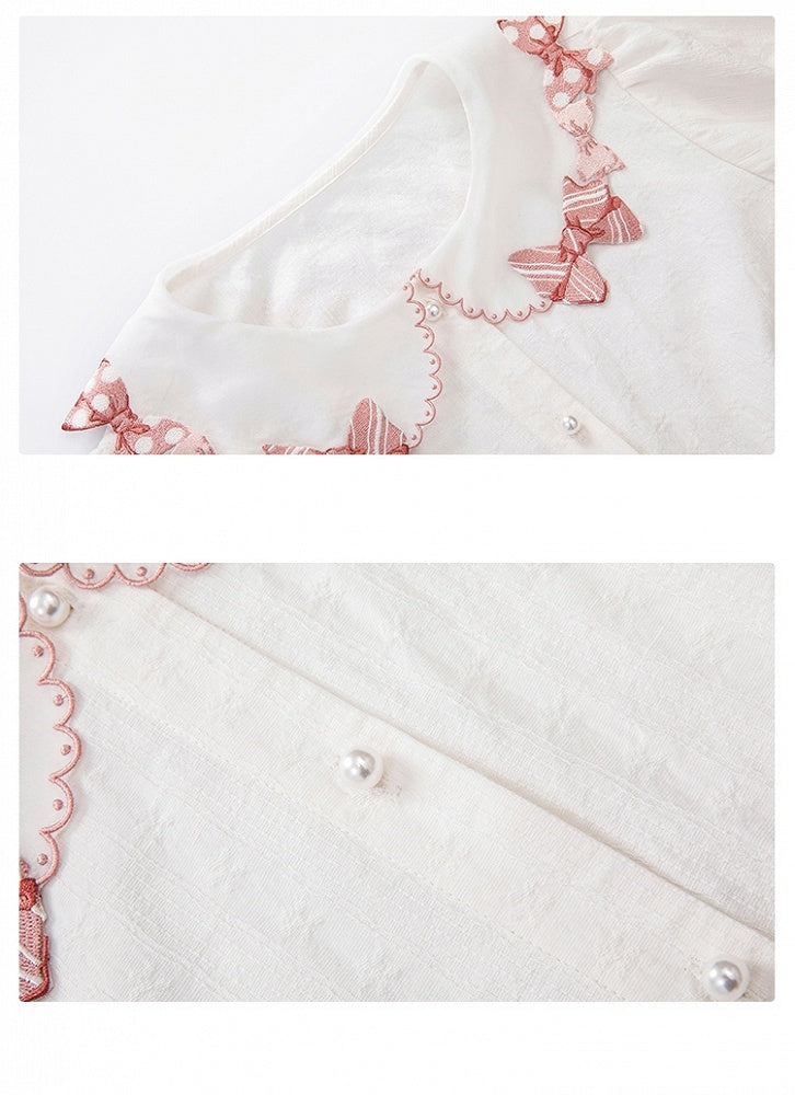 Rosa Bluse mit Schleifenbesatz und weißen Kurzarm