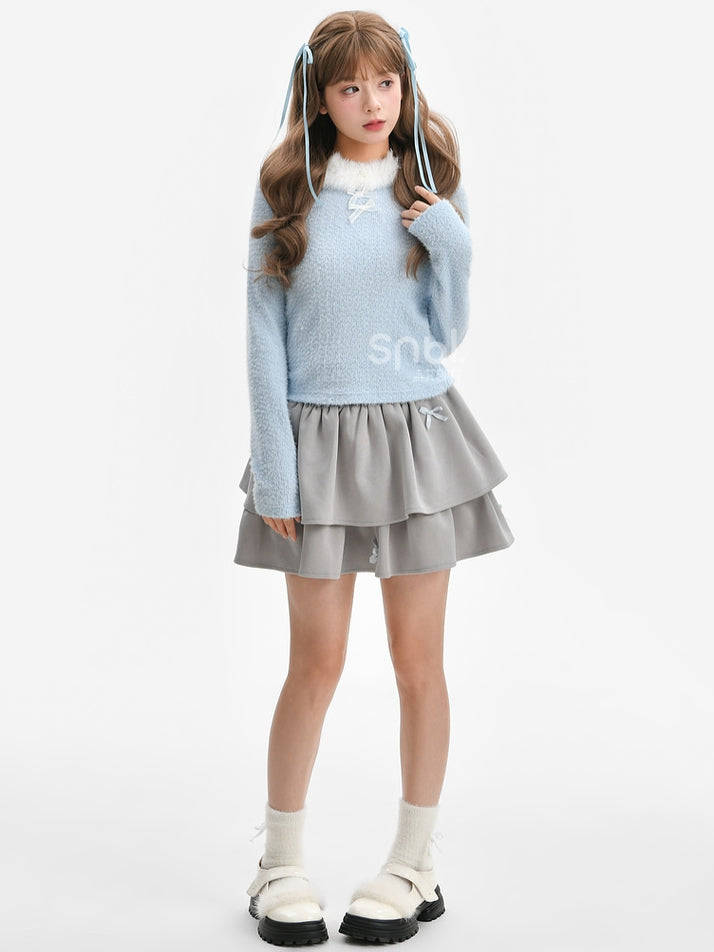 Haut à manches longues et col en peluche bleu avec détails nœud
