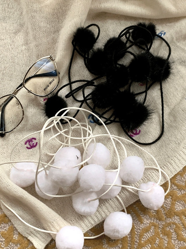 Schwarz/weiße Strumpfhose mit Tupfenmuster und Pompons