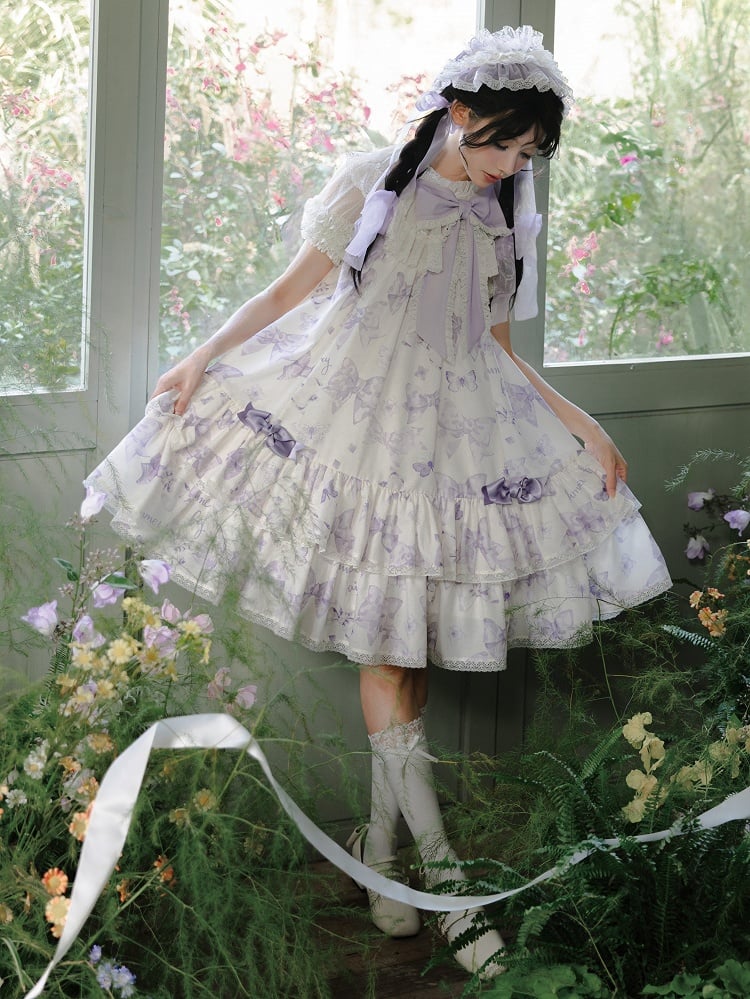Robe Lolita violette à gros nœud sur le décolleté et imprimé nœuds double épaisseur