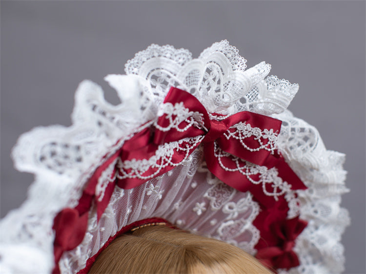 Bonnet avec bordure en dentelle et nœud blanc et rouge vin