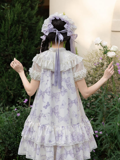 Robe Lolita violette à gros nœud sur le décolleté et imprimé nœuds double épaisseur