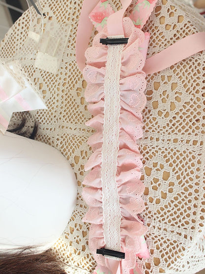 Bandeau rose avec détails de nœud papillon aux fraises et bordure en dentelle