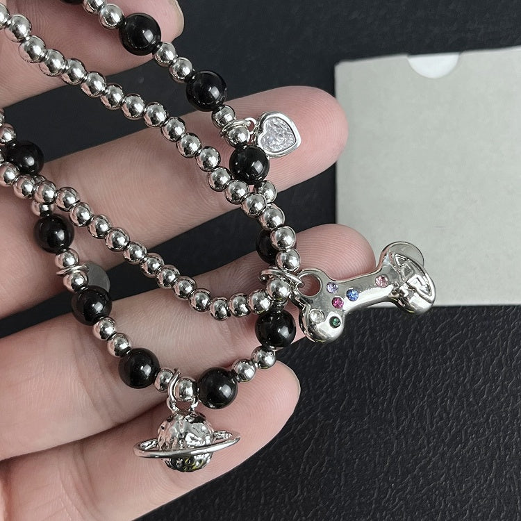 Bracelet à breloques en os de Saturne blanc/noir/rouge