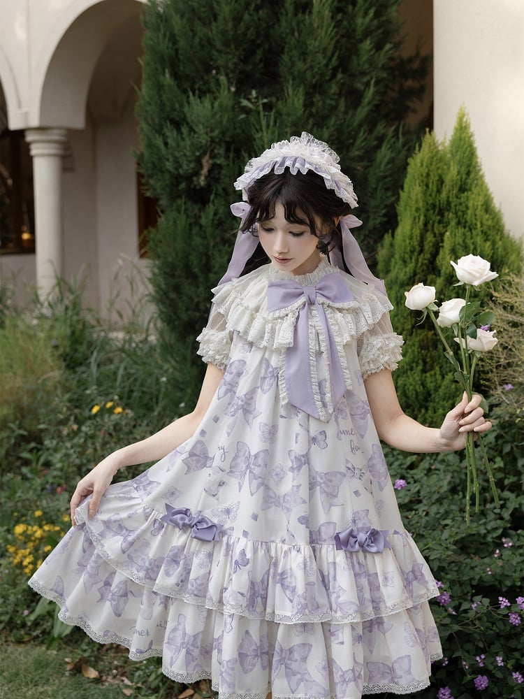 Robe Lolita violette à gros nœud sur le décolleté et imprimé nœuds double épaisseur