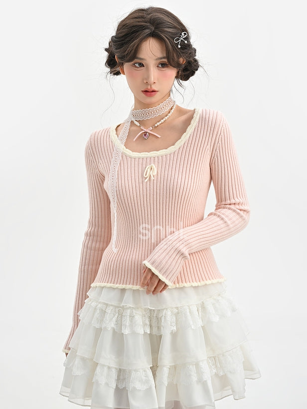 Haut en maille slim à col rond et détails nœud rose