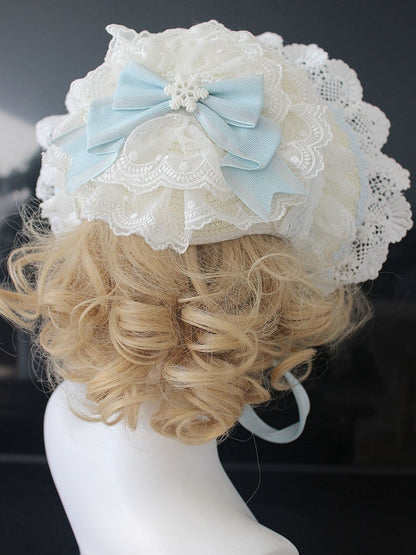Rosa/blaue Haube mit floralen Schleifendetails und Spitzenbesatz