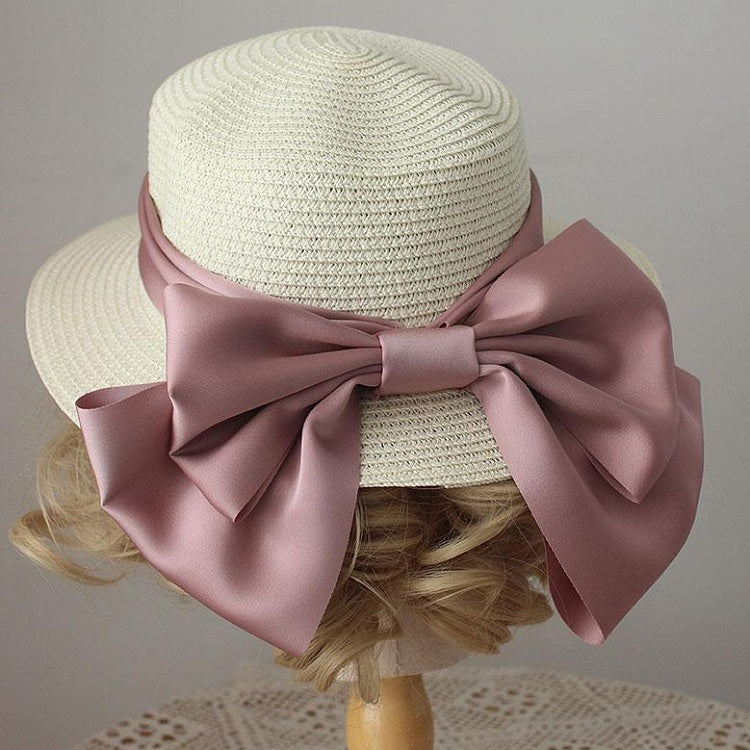 Chapeau de paille décoré d'un gros nœud