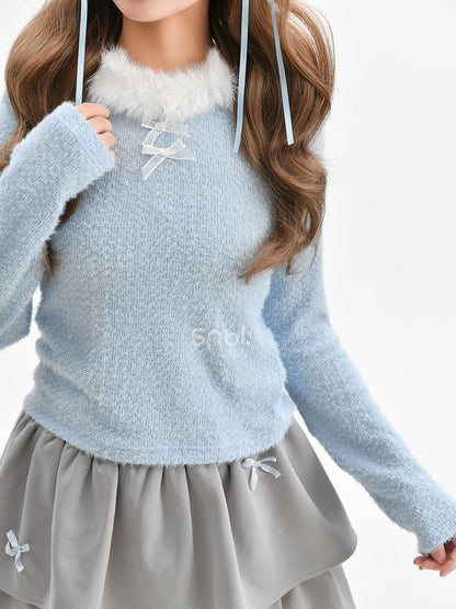 Haut à manches longues et col en peluche bleu avec détails nœud