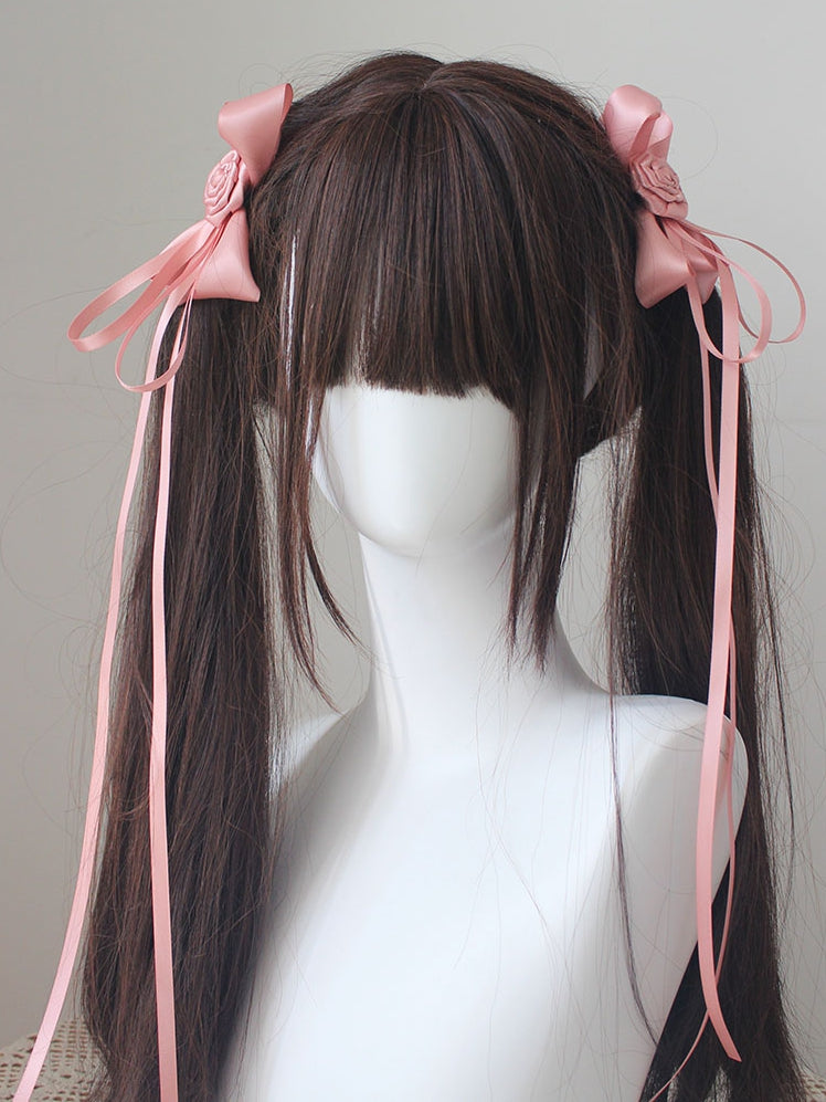 Pinces à cheveux roses décorées de rosaces avec détails de nœud papillon