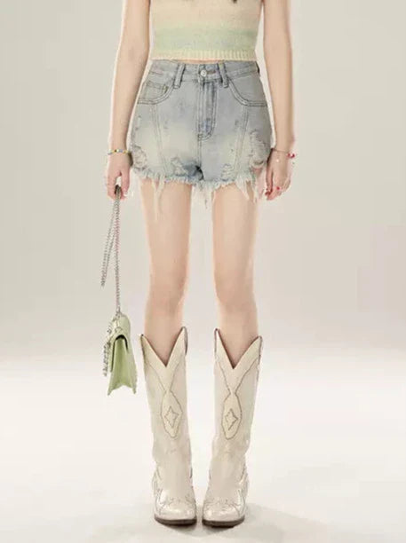 Short en jean taille basse à franges abîmées