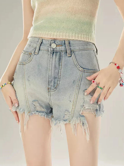 Short en jean taille basse à franges abîmées