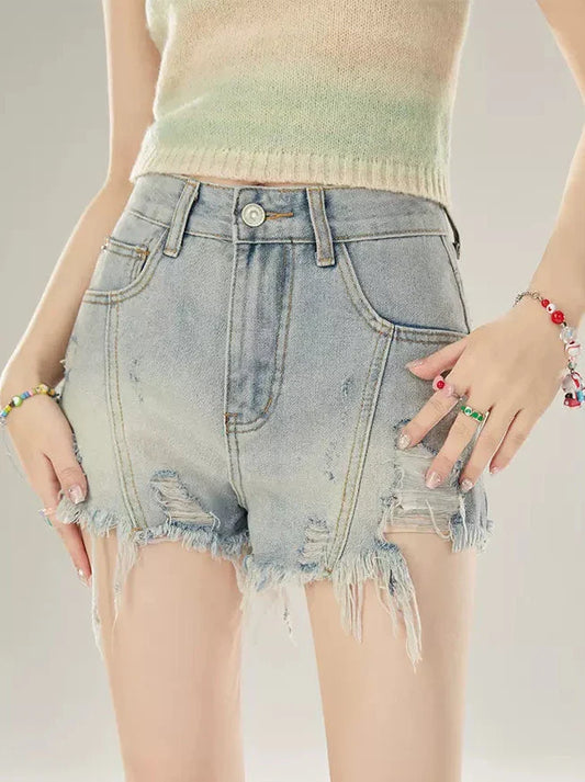 Short en jean taille basse à franges abîmées