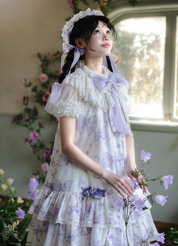 Robe Lolita violette à gros nœud sur le décolleté et imprimé nœuds double épaisseur