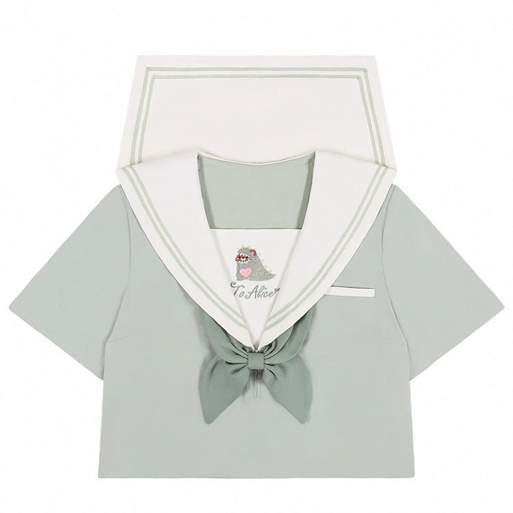Haut vert à col marin avec petit monstre mignon