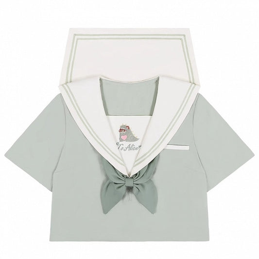 Haut vert à col marin avec petit monstre mignon