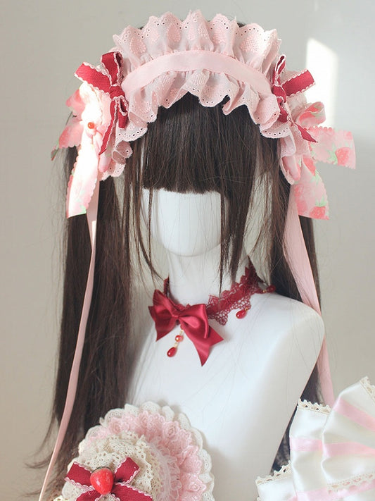 Bandeau rose avec détails de nœud papillon aux fraises et bordure en dentelle